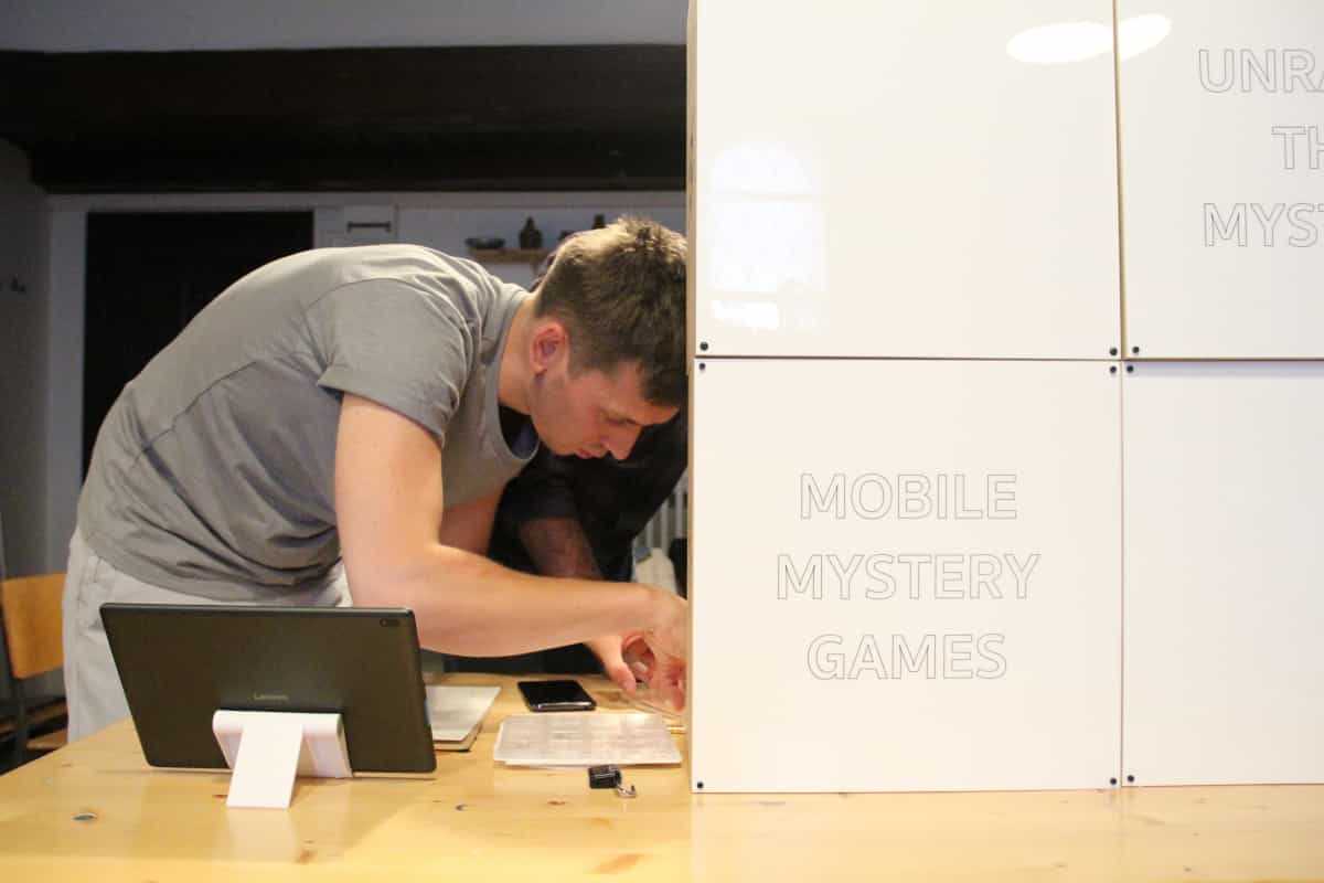 man solving the mobile mystery game escape room